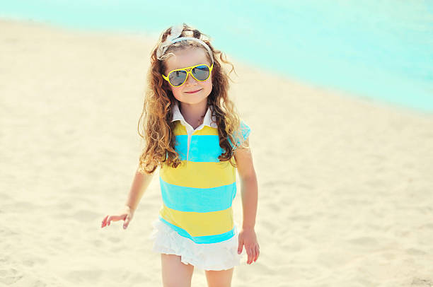 istock Summer vacation - child on beach wearing a sunglasses 499801954