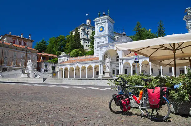 Bike parked in Piazza Libertà, Udine, Italy: riding along the Alpe Adria cycle route (Ciclovia Alpe Adria Radweg)