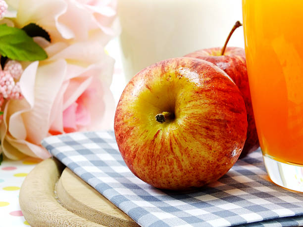 istock morning breakfast red apple with orange juice and milk 499803958