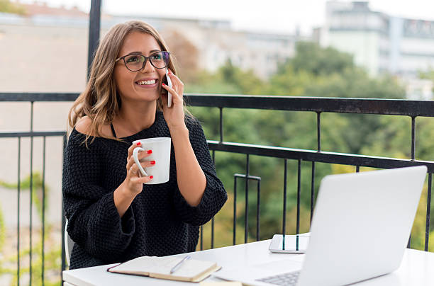 istock Smiling Young woman talking on mobile phone 499805158