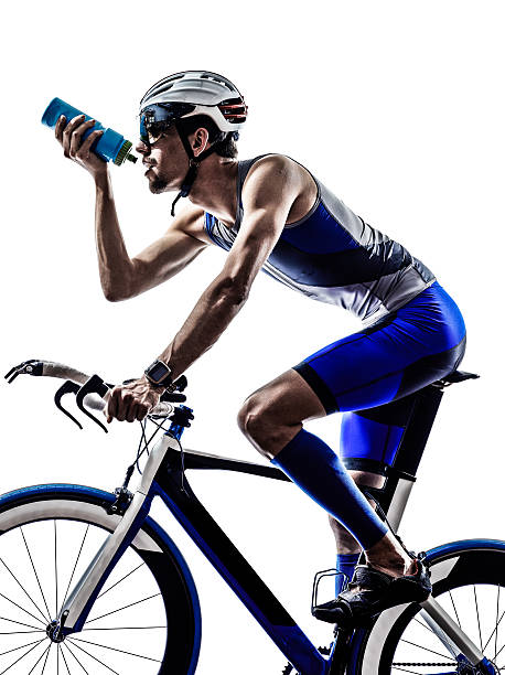 man triathlon iron man athlete biker cyclist bicycling biking drinking in silhouette on white background