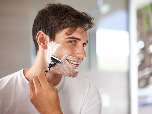 Enjoying his morning routine Cropped shot of a young man shaving his facial hair with a disposable bladehttp://195.154.178.81/DATA/i_collage/pi/shoots/783523.jpg razor blade photos stock pictures, royalty-free photos & images
