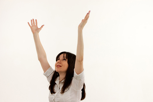 happy girl with raised arms on a white background.
