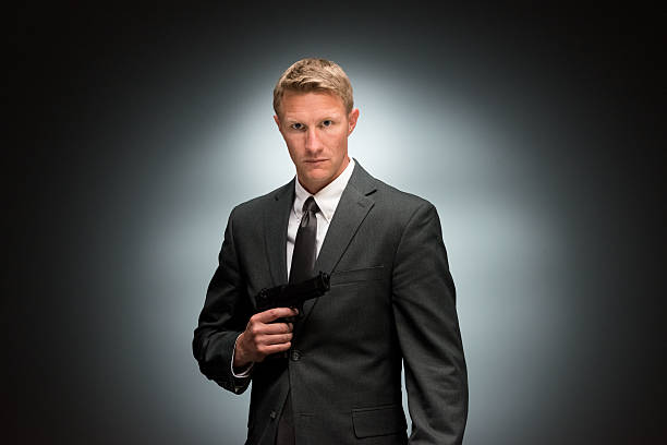 istock Spy holding handgun and looking at camera 499807074