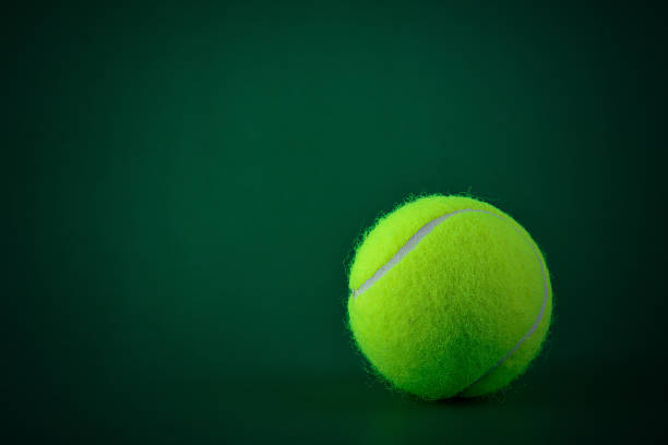istock tennis ball on green background 499807683