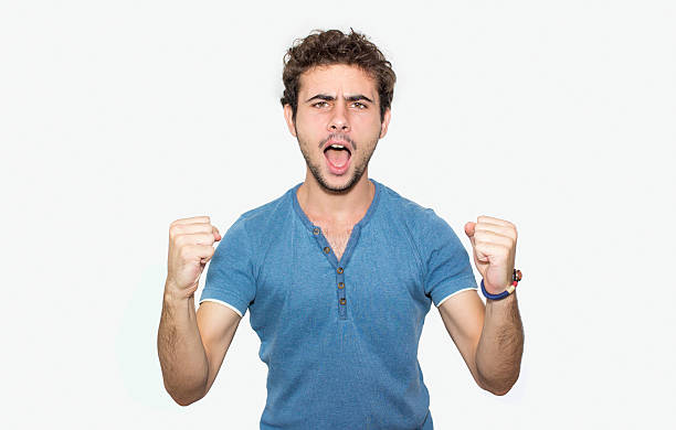 istock Portrait of cheering young man against white background 499808604
