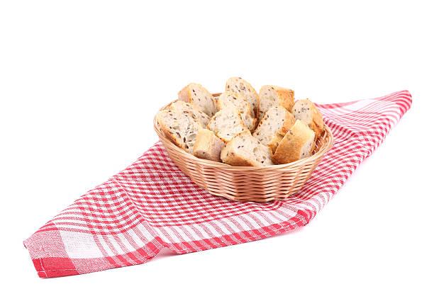istock Wicker basket full of bread on tablecloth. 499808955