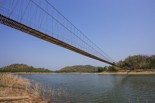 rope bridge to the island in the big dam Thailand