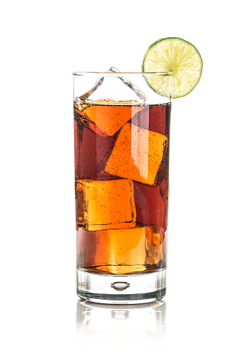Glass with cola, rum and lemon isolated on white.