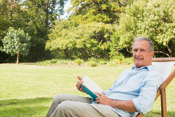 istock Happy mature man holding book 499812029