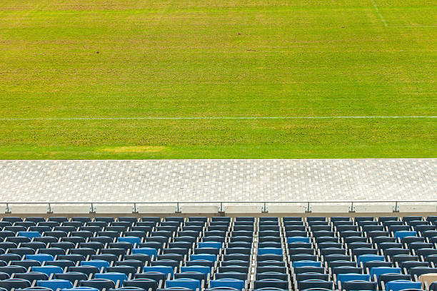 istock Stadium seats and green grass 499812683