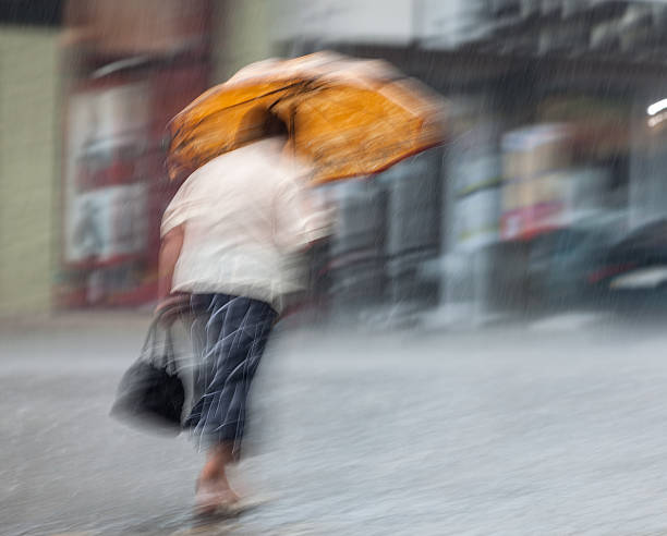 istock People walking down the street in rainy day 499840027