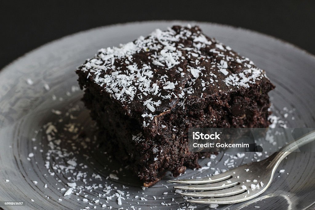 Chocolate Cake with Grated Coconut A piece of delicious dark chocolate cake with grated coconut. Chocolate Cake Stock Photo