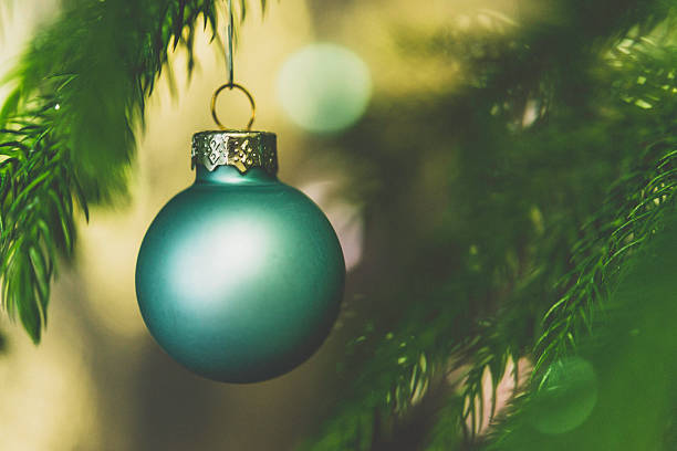 Pastel colored Christmas ornaments on Christmas tree branches