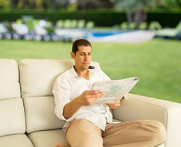 istock reading newspaper in garden 499843881