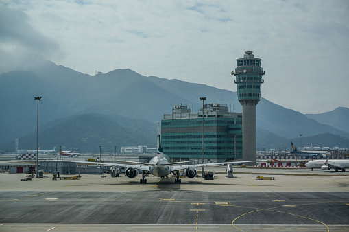 Hong Kong International Airport with control tower and Landtau peak at the back