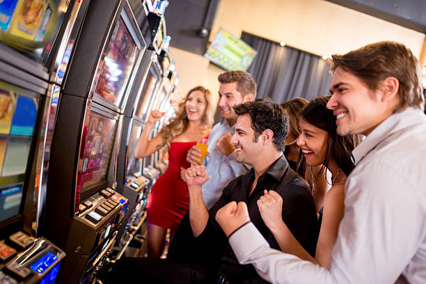 People winning at the casino Happy group of people winning at the casino coin operated stock pictures, royalty-free photos & images