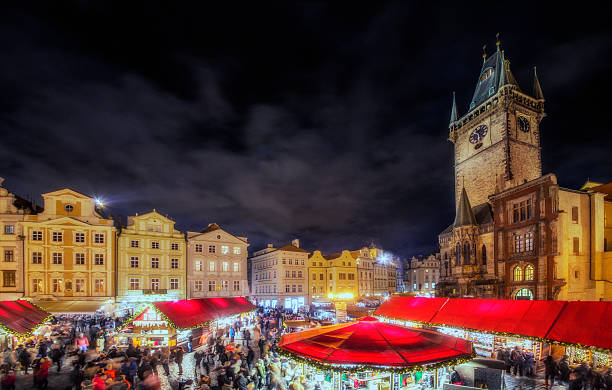 Christmas Market Prague Elevated panoramic view over Prags christmas market with the landmark townhall tower. prague christmas market stock pictures, royalty-free photos & images