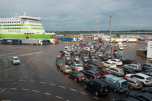 Tallinn, Estonia - July 8, 2015: Lines of vehicles wait to board the MS Star in the port of Tallinn, Estonia. The Star was built in 2007 and has a capacity for 450 cars and 2080 passengers. The ferry is operated by the Estonian ferry company Tallink and connects the cities of Tallinn and Helsinki.