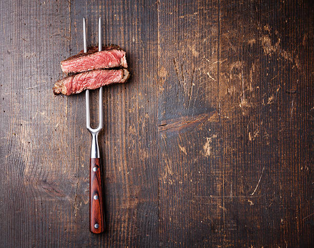 istock Slices of beef steak on meat fork 499846451