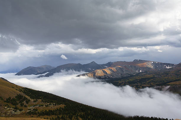 Fog rising in Forest canyon with Mount Ida in the background in Rocky Mountain National Park