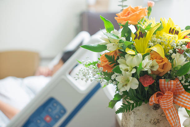 get well soon flowers Beutiful bouquet of flowers next to a hospital bed. Get well soon flowers get well soon stock pictures, royalty-free photos & images