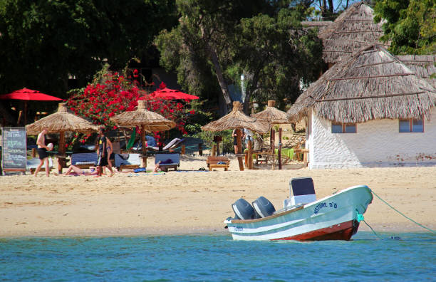 Madagascar: Beach at Ifaty Ifaty, Madagascar - August 5, 2015: Tourists relax on the pristine white sand beach at Ifaty in Madagascar, a small but popular beach resort in the southwest. mozambique channel stock pictures, royalty-free photos & images