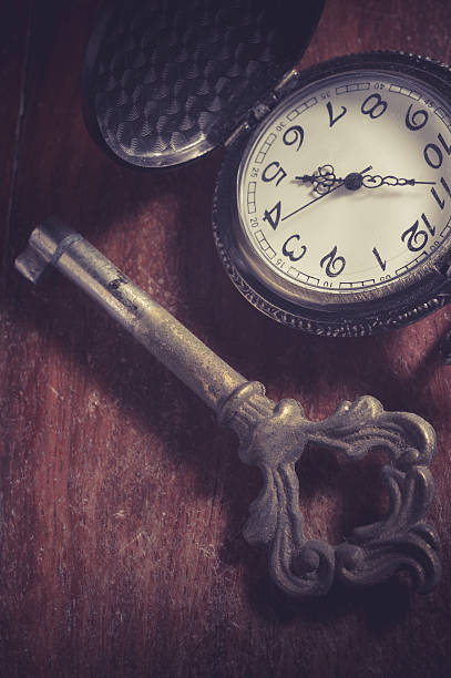 istock Old key with pocket watch,vintage filtered. 499854514