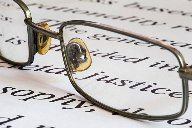 istock Eye glasses on a sheet containing the word justice 499855882