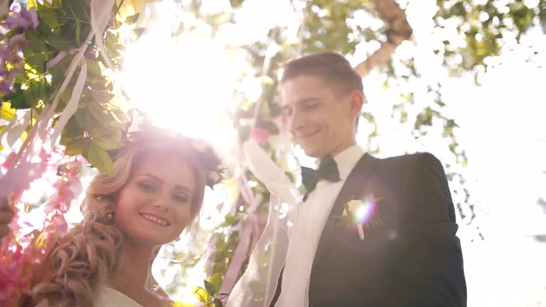 The groom throws a bride on a swing.