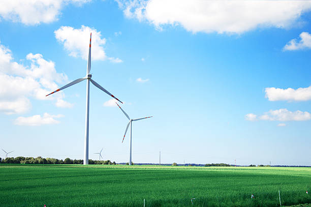 Windmill conceptual image. Windmills on the green field. environmental pressure oven photos stock pictures, royalty-free photos & images