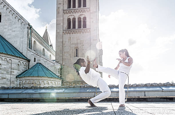istock Pair of capoeira performers doing a kicking 499867837