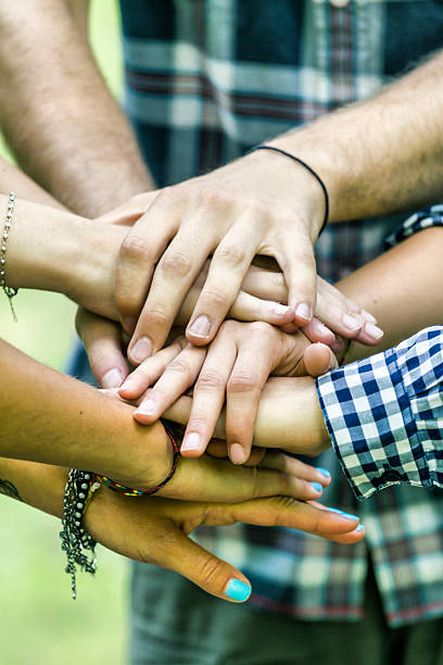 istock Group of friends joining hands 499869419