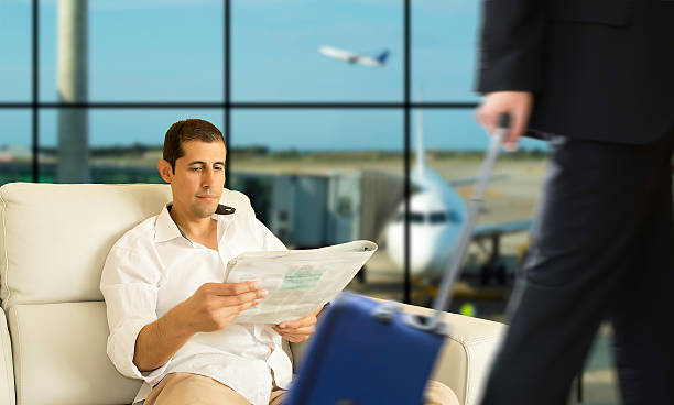 VIP area of an airport Business man waiting for his flight in the VIP area newspaper airport reading business person stock pictures, royalty-free photos & images