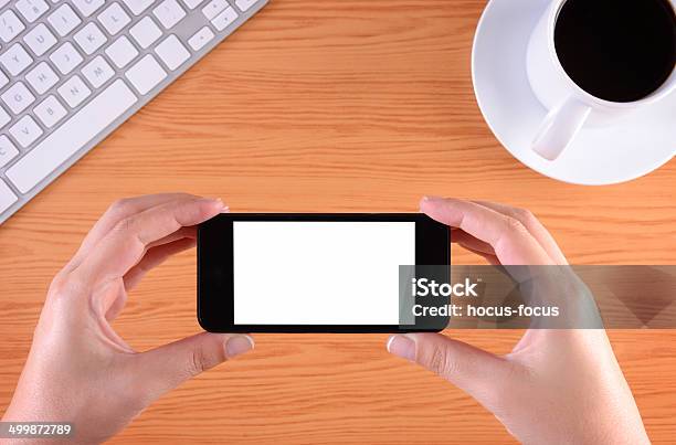Hands Holding Touchscreen Smart Phone At Office Stock Photo - Download Image Now - Adult, Black Color, Blank