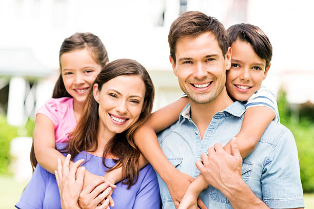 istock Parents Piggybacking Children At Yard 499873527