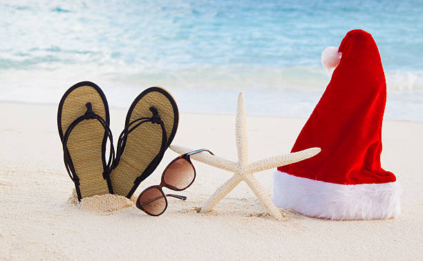 Perfect Christmas Holiday Santa Hat, Starfish, Sunglasses and Flip Flops on a Maldives Beach starfish sunglasses stock pictures, royalty-free photos & images