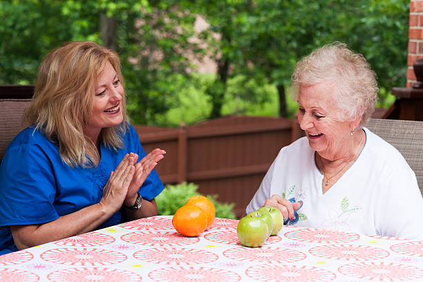 istock Home health speech therapy session outdoors 499875091