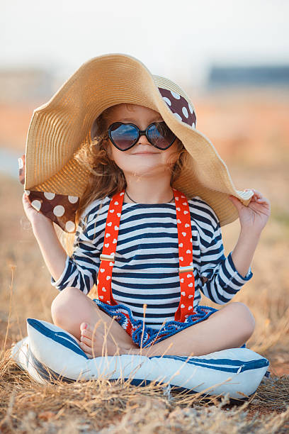 istock The happy little girl in a big hat 499875810