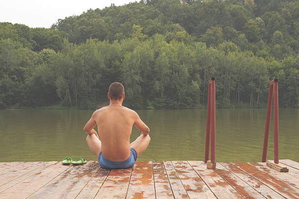 istock Meditating near water. 499882250
