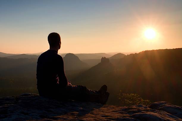 istock Tourist take a rest. Handsome young man in rocky  mountains. 499884910