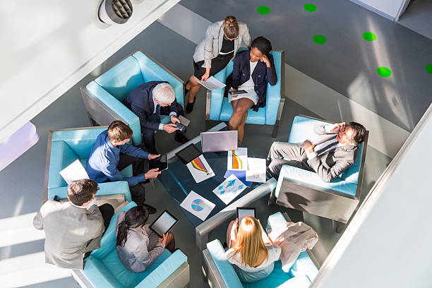 istock Group of happy ofiice worker sitting in lobby,having fun 499889230
