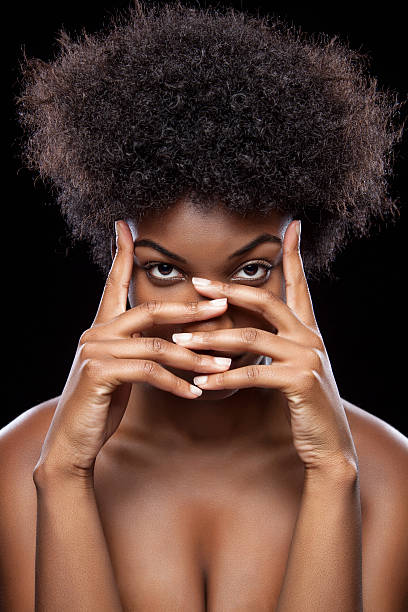 istock African beauty covering face with hands 499890201