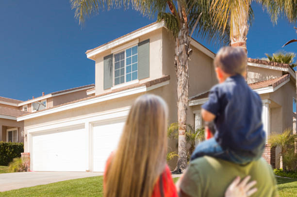 istock Mixed Race Young Family Looking At Beautiful Home 499891791