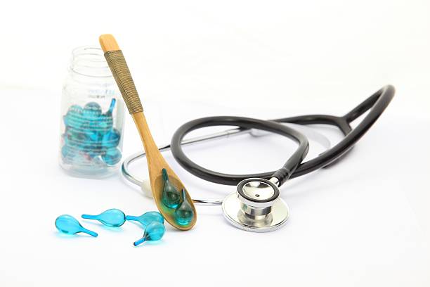 istock Vitamin pouring from wooden spoon and stethoscope 499892489