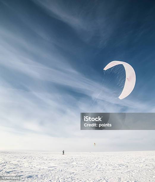 Kiteboarder With Blue Kite On The Snow Stock Photo - Download Image Now - Activity, Adult, Adults Only