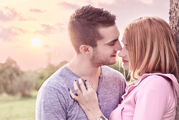 istock Beautiful couple embracing on date in sunset 499894289