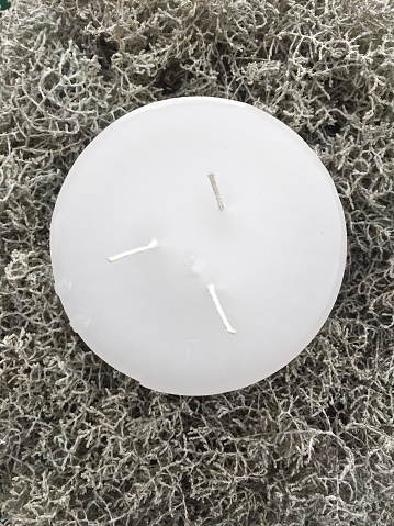 Round white candle with three wicks from above