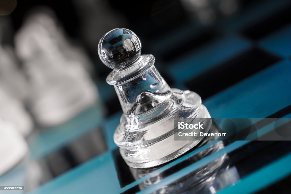 Macro Of Transparent Pawn On Blue Chessboard With Crooked Angle Macro Of A Transparent Pawn On Blue Chessboard With Crooked Angle 2015 Stock Photo