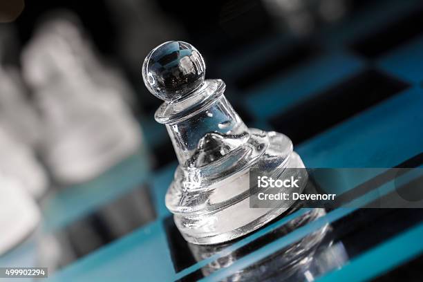 Macro Of Transparent Pawn On Blue Chessboard With Crooked Angle Stock Photo - Download Image Now